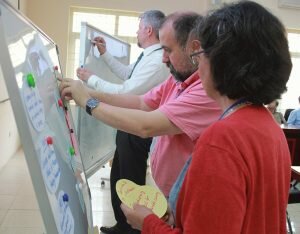 three researchers at pinboard