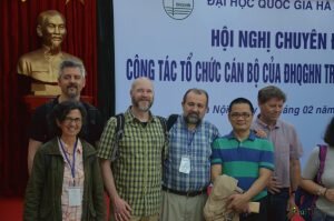 part of the group smiling in front of HochiMinh statue